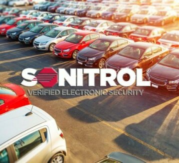 Sonitrol logo overlaying a car dealership parking lot