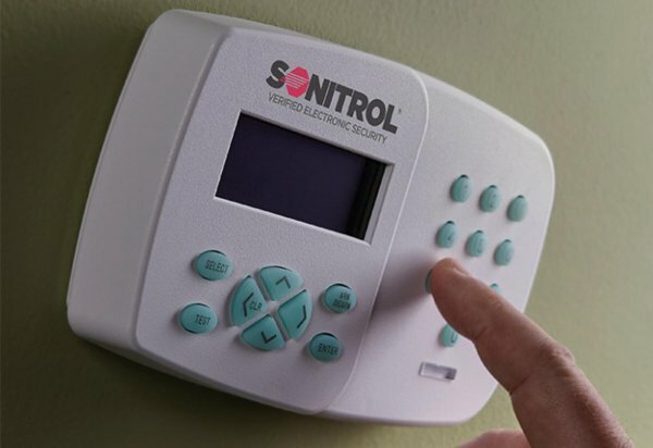 person using sonitrol keypad